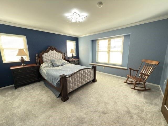 bedroom with ornamental molding and light colored carpet