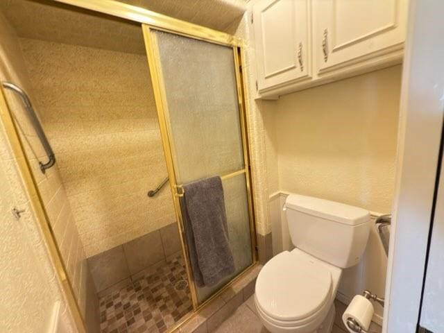 bathroom with toilet and walk in shower