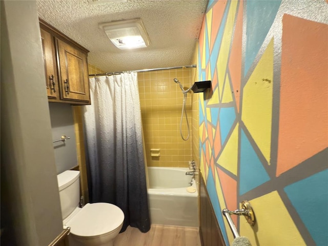 bathroom featuring shower / tub combo, hardwood / wood-style flooring, toilet, and a textured ceiling