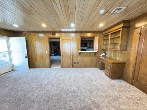 living room with carpet flooring, built in desk, and wooden ceiling