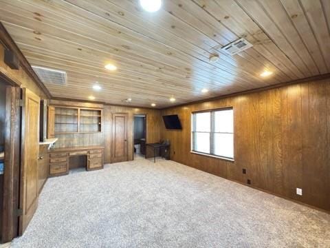 living room with carpet floors, built in desk, wooden ceiling, and wooden walls