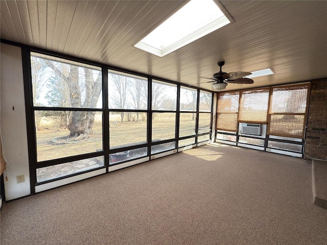 unfurnished sunroom with cooling unit, ceiling fan, a healthy amount of sunlight, and a skylight