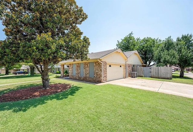 ranch-style house featuring a garage, central AC, and a front yard