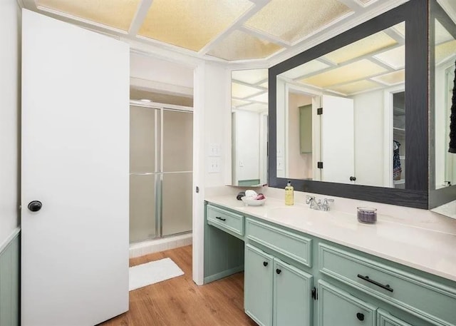 bathroom with vanity, hardwood / wood-style floors, and walk in shower