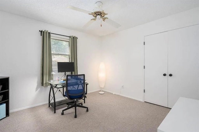 carpeted office with ceiling fan and a textured ceiling