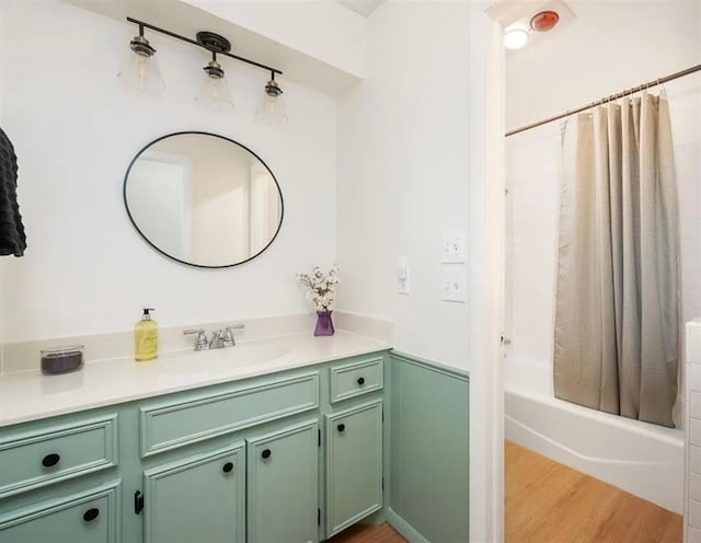 bathroom featuring vanity, hardwood / wood-style floors, and shower / tub combo with curtain