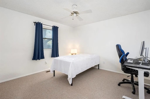 carpeted bedroom with a textured ceiling and ceiling fan