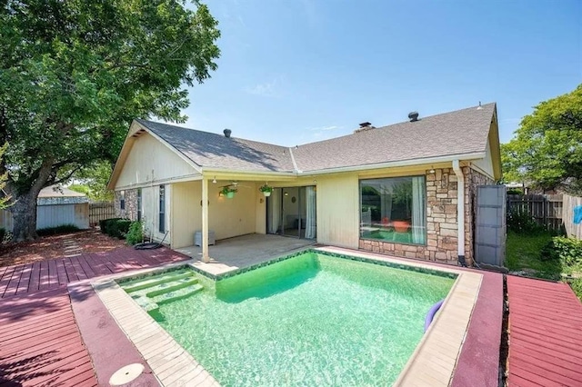 rear view of property with a pool side deck and a patio area