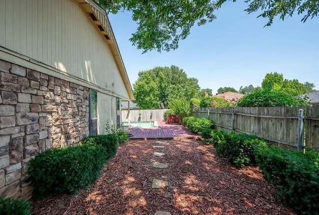 view of yard featuring a deck and a patio