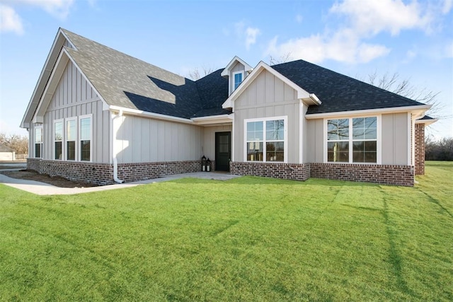 rear view of property featuring a lawn