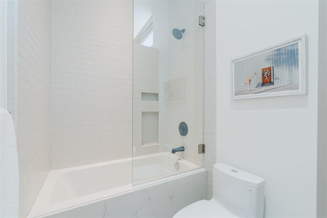 bathroom with tiled shower / bath and toilet