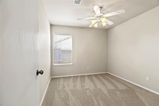 carpeted empty room featuring visible vents, baseboards, and a ceiling fan