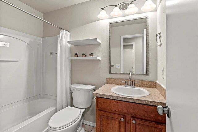 full bath featuring shower / bath combo with shower curtain, vanity, and toilet