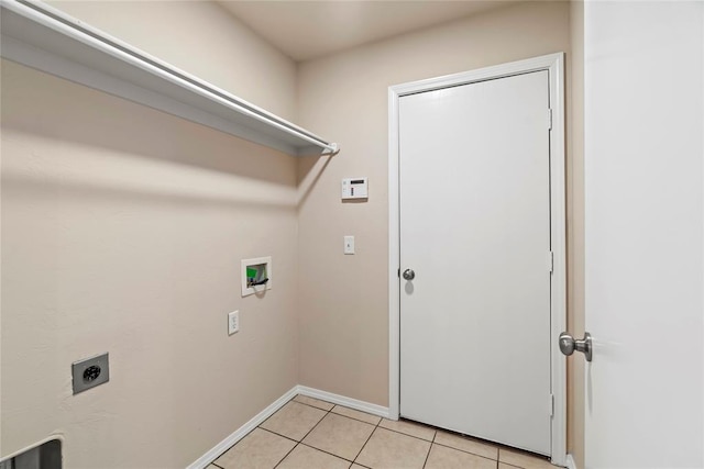 laundry area with light tile patterned floors, baseboards, washer hookup, laundry area, and electric dryer hookup