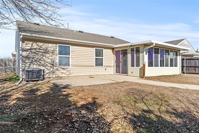 rear view of property with a patio area, a sunroom, cooling unit, and fence