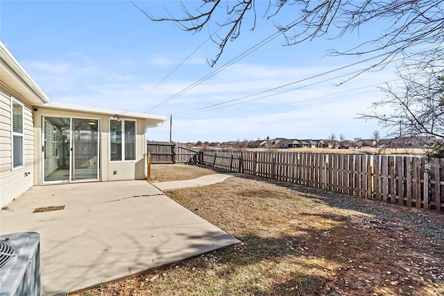 view of yard featuring a patio, central AC unit, and a fenced backyard