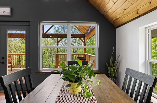 dining area featuring vaulted ceiling and wooden ceiling