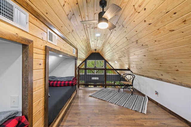 bonus room featuring lofted ceiling, wood ceiling, dark hardwood / wood-style floors, wooden walls, and ceiling fan