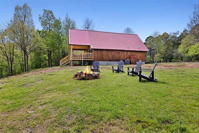 view of yard with a deck and an outdoor fire pit