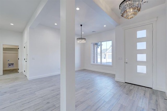 foyer entrance featuring an inviting chandelier