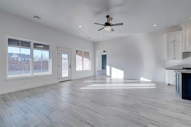 unfurnished living room featuring ceiling fan