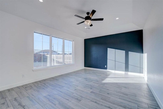 spare room with ceiling fan and lofted ceiling