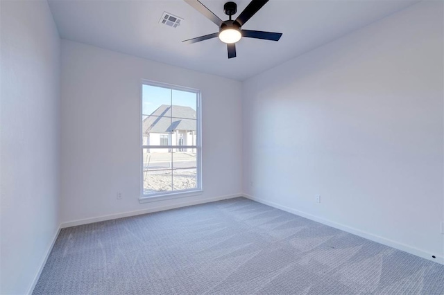 spare room featuring ceiling fan and carpet