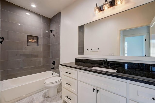 full bathroom featuring vanity, tiled shower / bath combo, and toilet