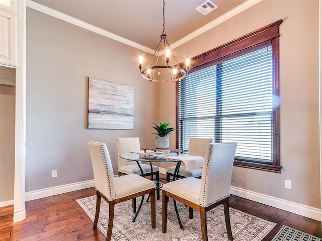 dining room featuring ornamental molding, a notable chandelier, and dark hardwood / wood-style flooring