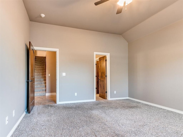 unfurnished bedroom with ceiling fan, light colored carpet, and lofted ceiling