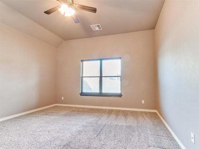 carpeted spare room featuring lofted ceiling and ceiling fan