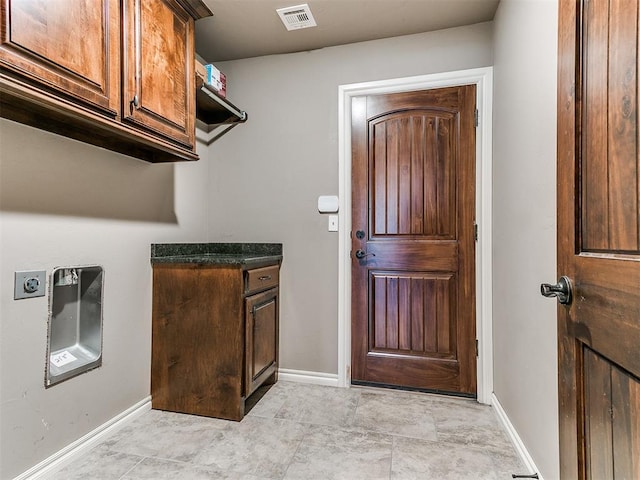 washroom with cabinets and hookup for an electric dryer