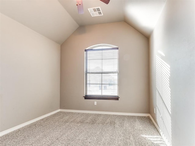 unfurnished room featuring lofted ceiling, ceiling fan, and carpet flooring