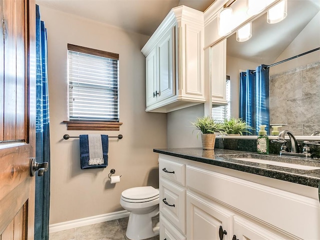 bathroom featuring vanity, tile patterned floors, and toilet