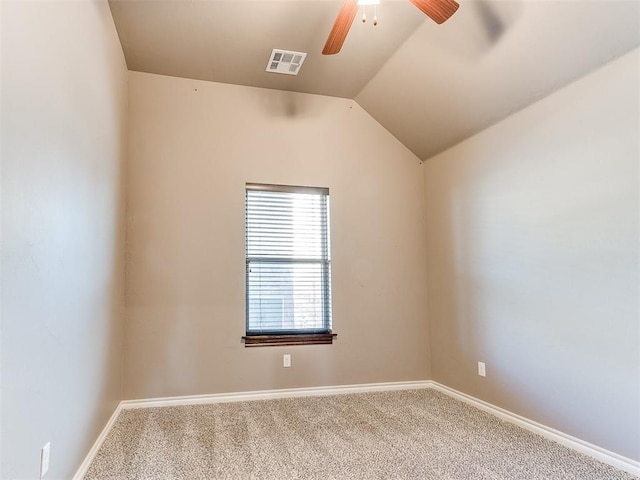 empty room featuring ceiling fan, lofted ceiling, and carpet floors