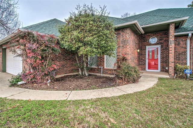 obstructed view of property featuring a garage and a front lawn