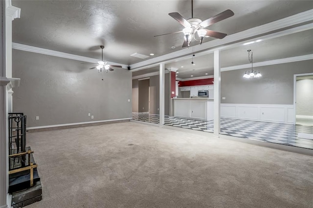 unfurnished living room featuring crown molding, a textured ceiling, ceiling fan, and carpet