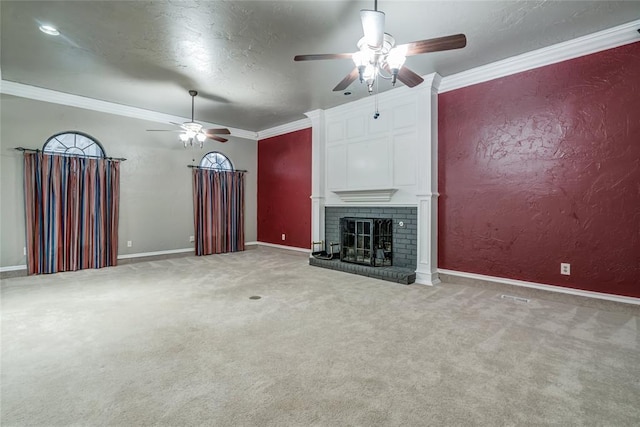 unfurnished living room with a fireplace, ornamental molding, ceiling fan, and carpet