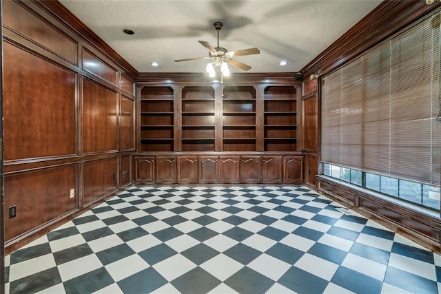 unfurnished office with built in shelves, ornamental molding, and wooden walls