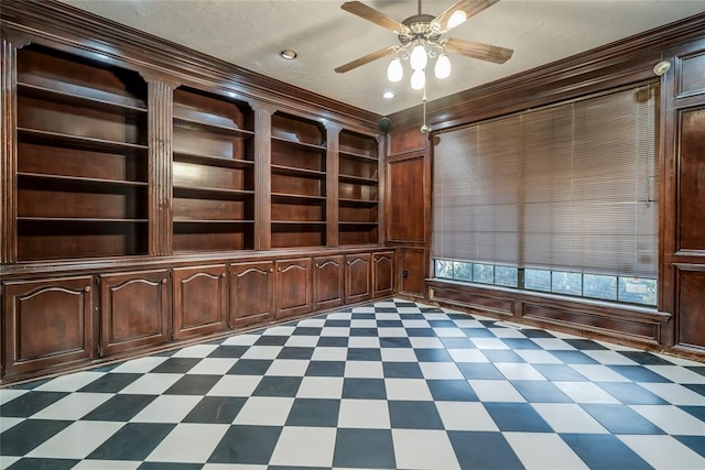 unfurnished office featuring ornamental molding, wooden walls, built in features, and ceiling fan