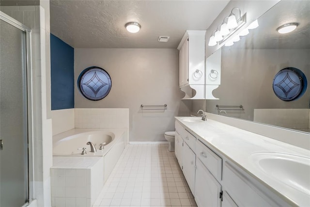 full bathroom with tile patterned floors, plus walk in shower, a textured ceiling, and vanity