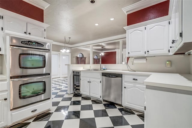 kitchen featuring decorative light fixtures, white cabinetry, ornamental molding, kitchen peninsula, and stainless steel appliances