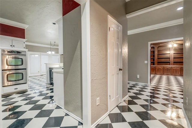 hall with crown molding, wine cooler, and a chandelier