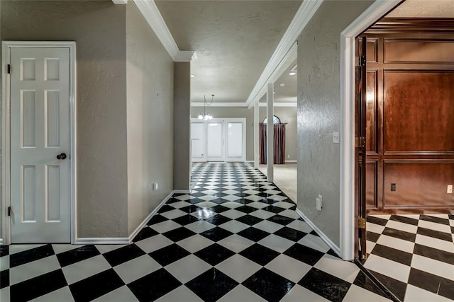 hallway with ornamental molding and a chandelier