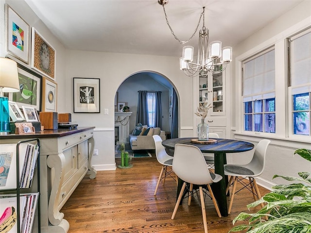 dining room with hardwood / wood-style floors and a notable chandelier