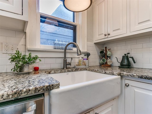 kitchen featuring tasteful backsplash, sink, wine cooler, white cabinets, and light stone countertops