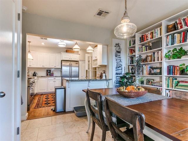 dining area featuring light tile patterned flooring