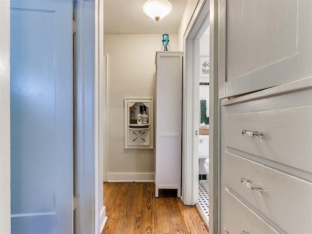 corridor with light hardwood / wood-style floors