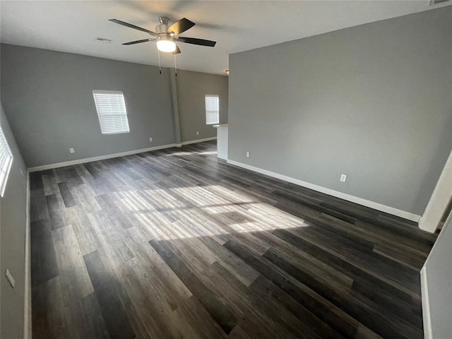 unfurnished room with dark wood-type flooring and ceiling fan