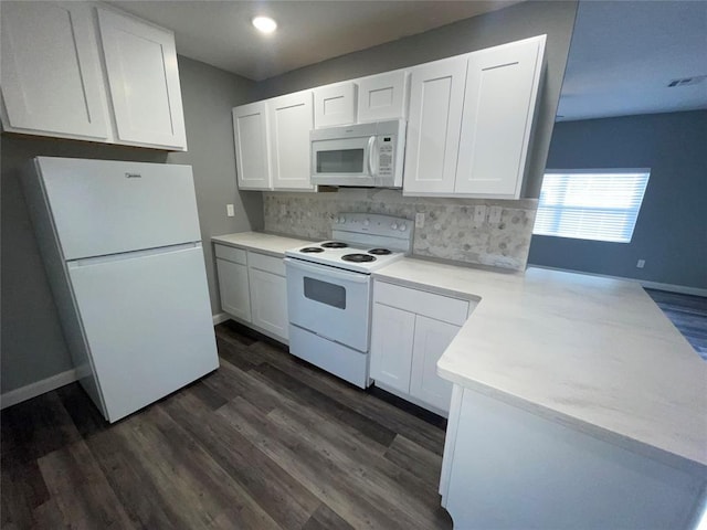 kitchen with backsplash, white appliances, kitchen peninsula, and white cabinets